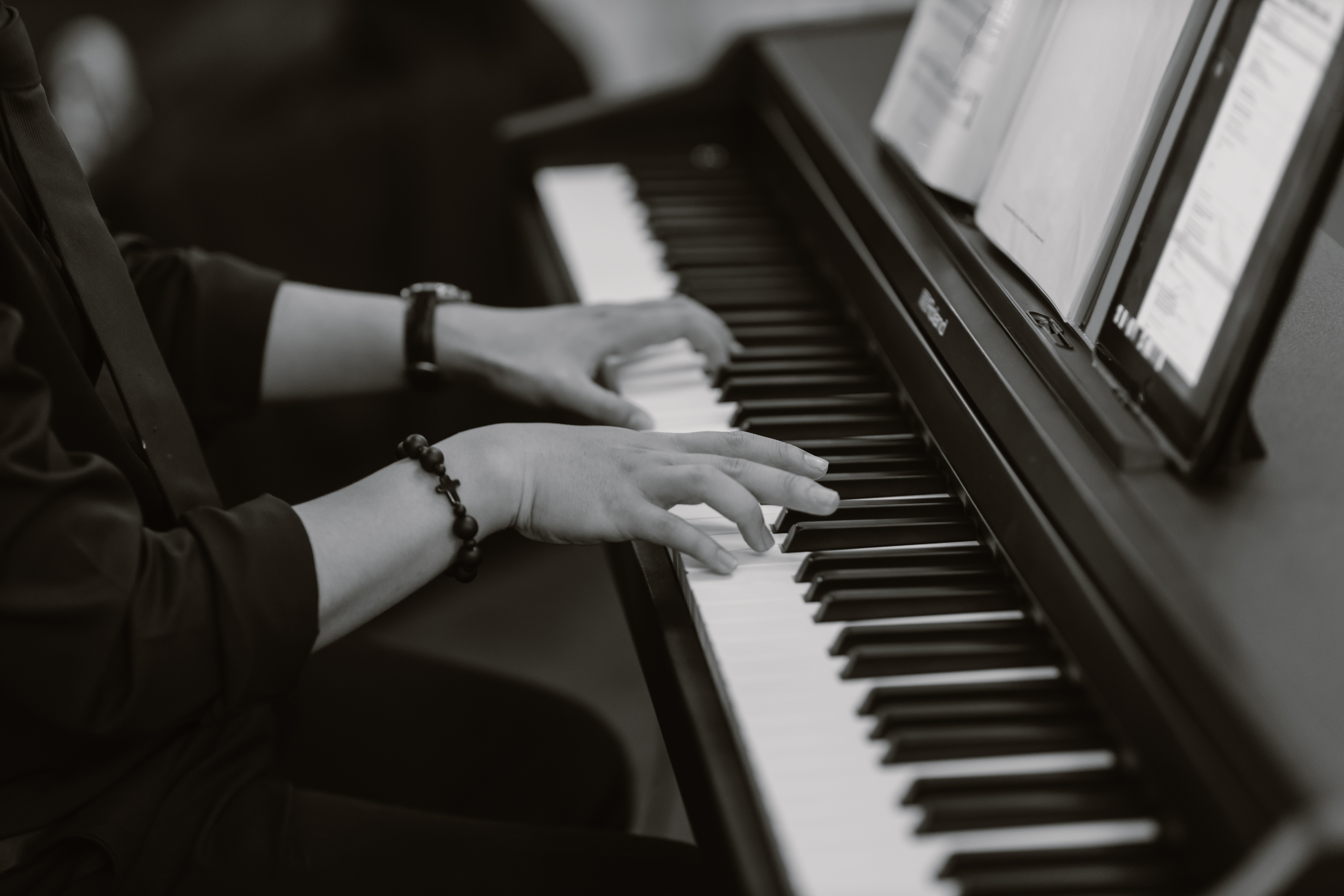 side-view of student playing on a digital piano
