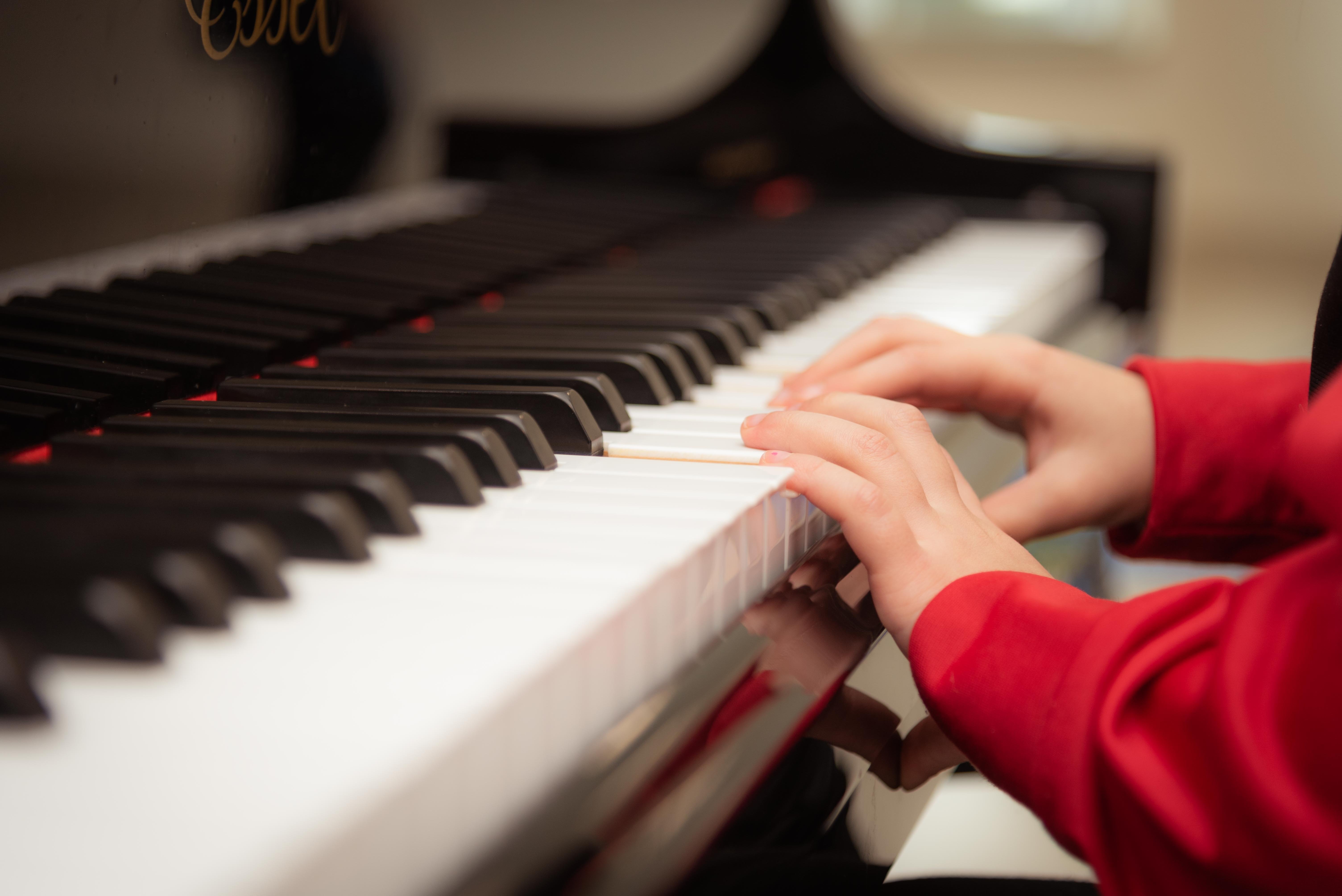 side-view of piano with a child playing casually